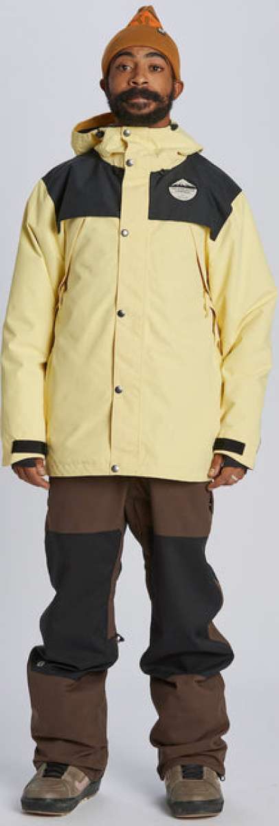 Airblaster Guide Shell Jacket 2024 - A cream-colored jacket with black shoulder panels and a hood, featuring silver snap buttons.