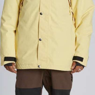 Airblaster Guide Shell Jacket 2024 - A cream-colored jacket with black shoulder panels and a hood, featuring silver snap buttons.