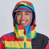 Airblaster Women's Freedom Stretch Suit 2024 - A woman wearing a black, purple, and pink suit with a geometric pattern on the arms and legs.