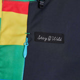 Airblaster Women's Freedom Stretch Suit 2024 - A black, red, yellow, and green full-body snowsuit with a zipper down the front.