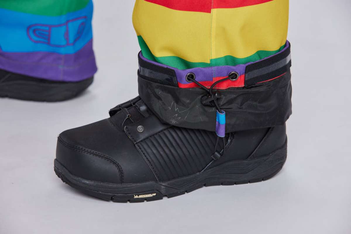 Airblaster Women's Freedom Stretch Suit 2024 - A black, high-top boot with a textured pattern on the side and a purple tag hanging from the laces.