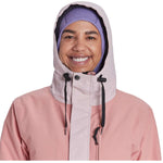 Airblaster Women's Stay Wild Insulated Parka 2024 - A pink parka with a hood and black drawstrings.