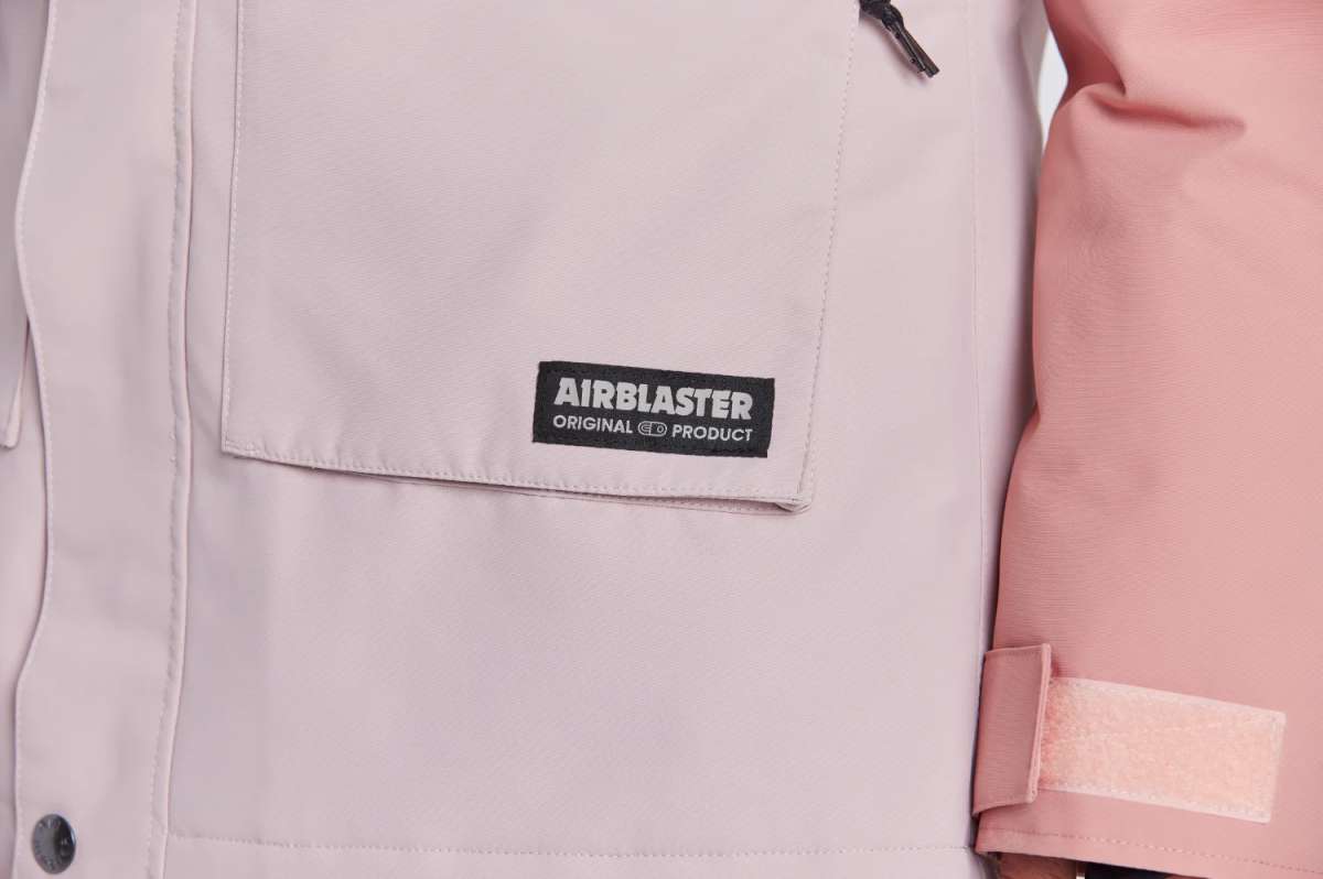 Airblaster Women's Stay Wild Insulated Parka 2024 - A parka with a black zipper and two zippered pockets on the front, featuring a white logo patch that reads "Airblaster" in bold letters.