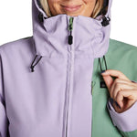 Airblaster Women's Stretch Freedom Suit 2023 - A light purple and green two-tone snowsuit with a black zipper on the chest.