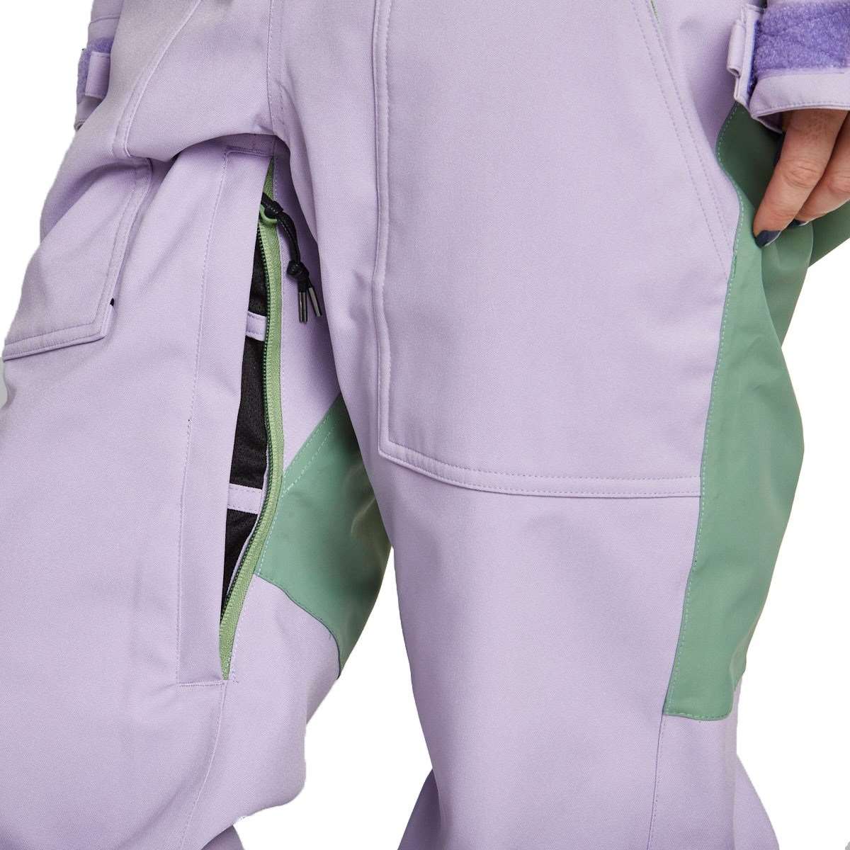 Airblaster Women's Stretch Freedom Suit 2023 - A lavender-colored snowsuit with a black zipper and white stitching on the front pocket.