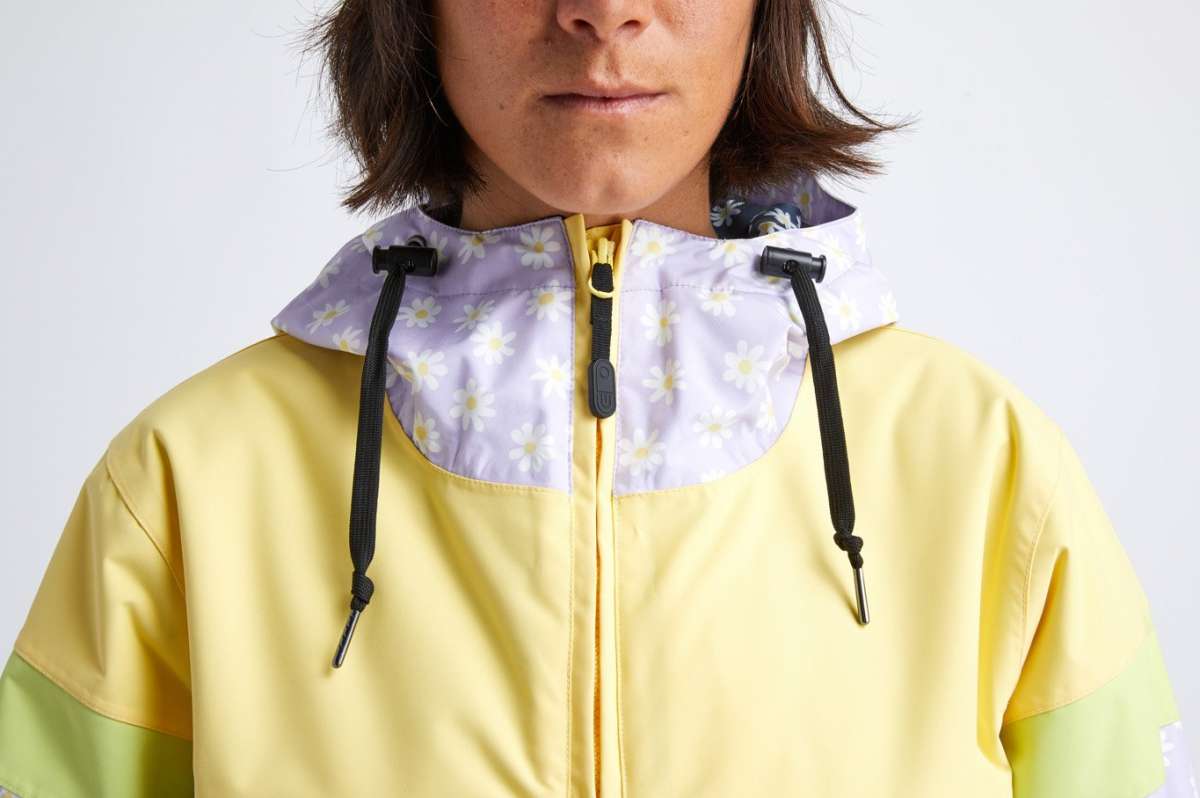 Airblaster Women's Trenchover Insulated Jacket 2022 - A women's insulated jacket with a hood, featuring a purple and white floral pattern on the upper portion of the hood.