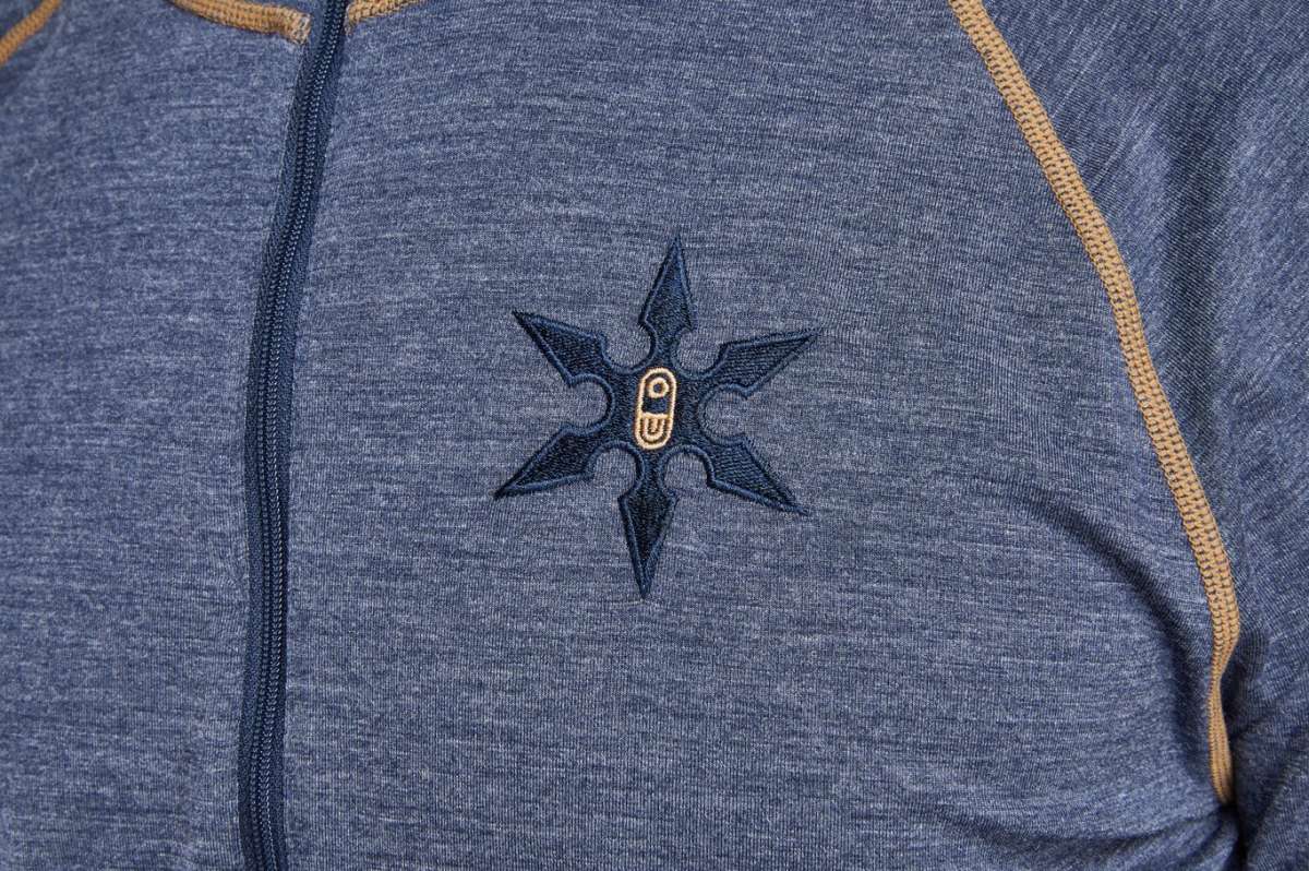 Airblaster Ninja Suit Merino 2022 - A heathered grey suit with a black embroidered ninja star logo on the chest.