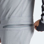 Airblaster Ninja Suit Pro II 2023 - Black zippered pocket on the back of a model wearing the suit, with black and white striped pattern.