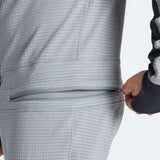 Airblaster Ninja Suit Pro II 2023 - Black zippered pocket on the back of a model wearing the suit, with black and white striped pattern.