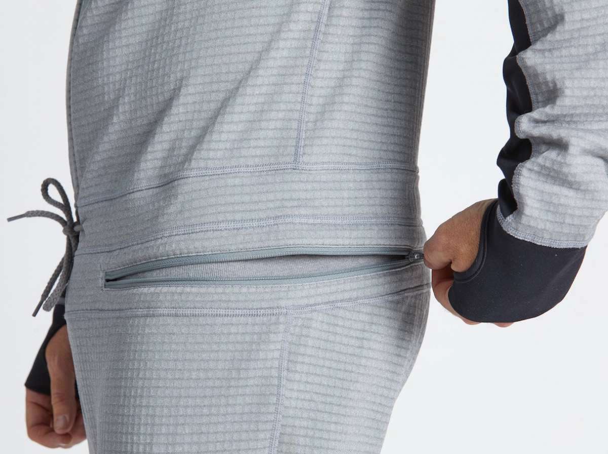 Airblaster Ninja Suit Pro II 2023 - Black zippered pocket on the back of a model wearing the suit, with black and white striped pattern.