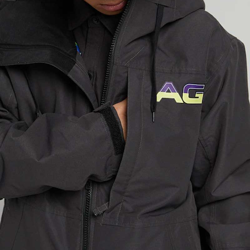 Analog Greed Jacket - A black jacket with a blue logo on the left chest and a white tag on the right sleeve.