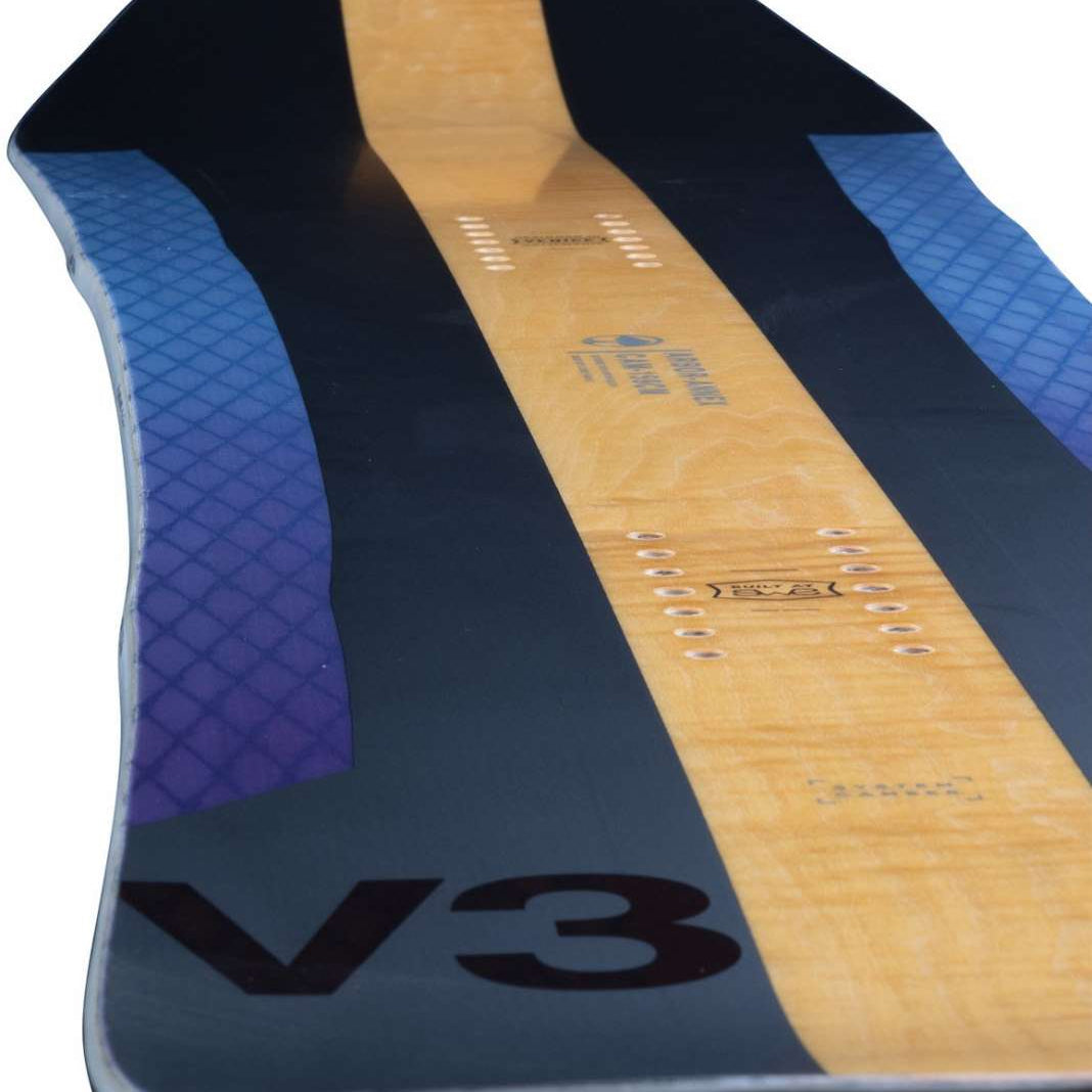 Arbor Annex Bi Camber Snowboard 2023 - A black snowboard with a blue and purple patterned design on the top sheet, featuring a distinctive bi-camber shape.