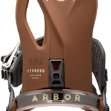 Arbor Cypress Snowboard Binding 2023 - A brown snowboard binding with a white eagle logo on top and a beige strap.