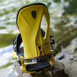 Arbor Cypress Snowboard Bindings 2024 - A pair of yellow snowboard bindings with black straps and buckles, featuring a distinctive triangular logo on top.