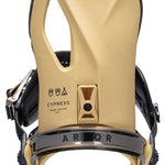 Arbor Cypress Snowboard Bindings 2024 - A pair of tan snowboard bindings with a black strap and silver buckles.