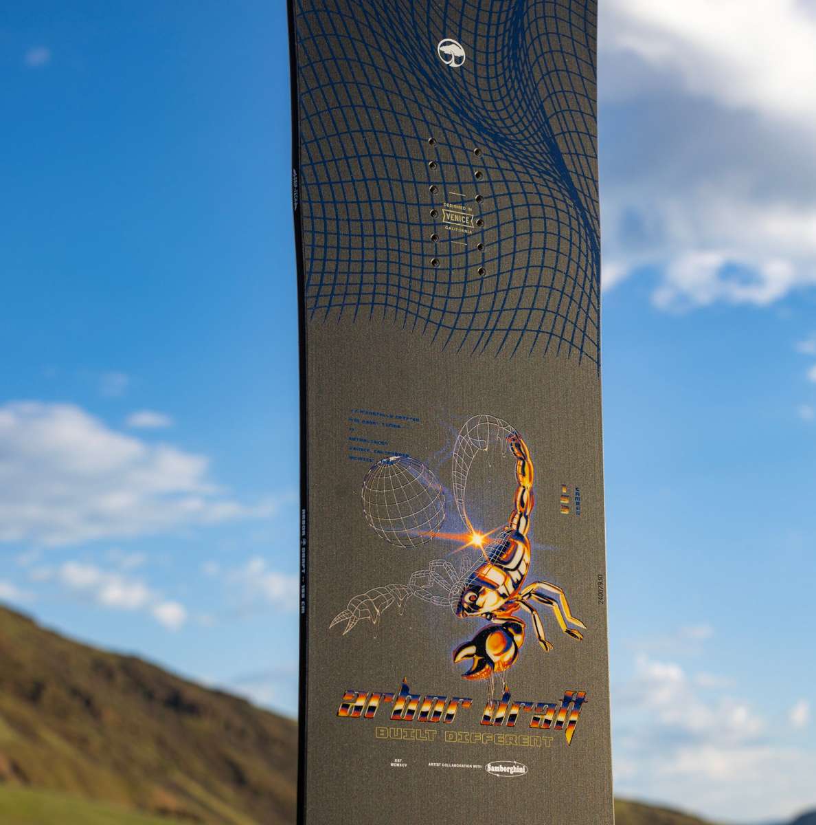 Arbor Draft Camber Snowboard 2024 - A black snowboard with a white logo and blue lines on top.