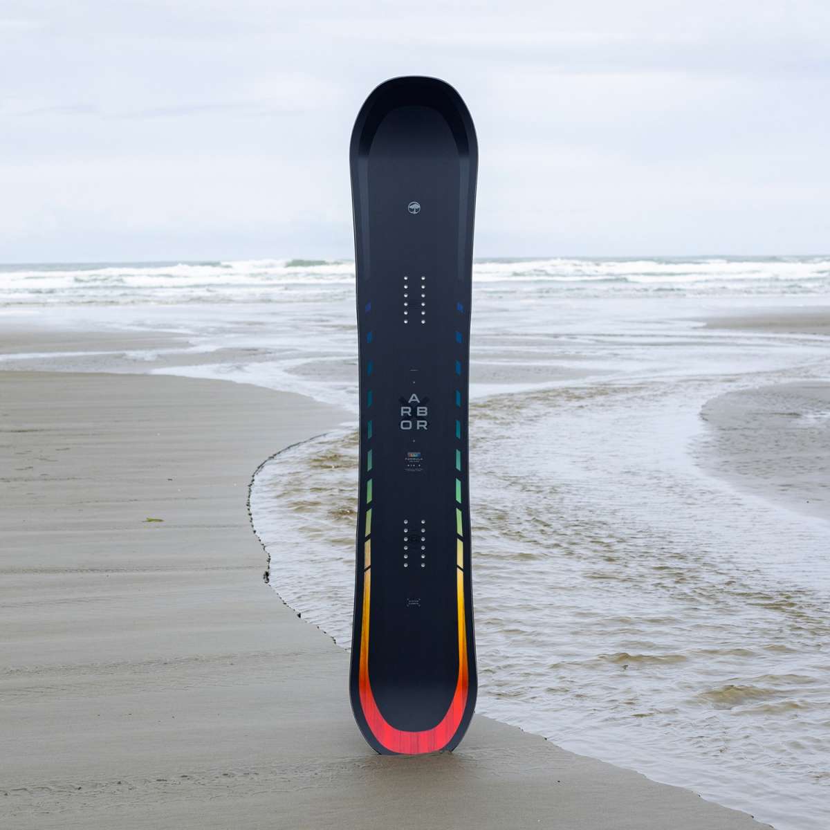 Arbor Formula Rocker Snowboard 2024 - A black snowboard with a rainbow-colored stripe along its bottom edge.