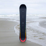 Arbor Formula Rocker Snowboard 2024 - A black snowboard with a rainbow-colored stripe along its bottom edge.