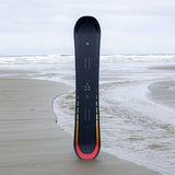 Arbor Formula Rocker Snowboard 2024 - A black snowboard with a rainbow-colored stripe along its bottom edge.