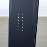 Arbor Formula Rocker Snowboard 2024 - A dark gray snowboard with a geometric pattern of lighter gray lines and shapes on top, featuring blue accents along the edges.