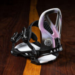 Arbor Hemlock Snowboard Bindings 2023 - A pair of black snowboard bindings with white accents and a distinctive logo on the straps.