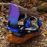 Arbor Hemlock Snowboard Bindings 2024 - Black bindings with purple accents and a black strap on top of a wood log in the woods.
