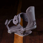 Arbor Women's Sequoia Snowboard Bindings 2023 - A pair of dark gray snowboard bindings with a textured strap and white lettering on the front.