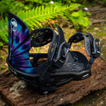 Arbor Sapling Youth Snowboard Bindings 2024 - A pair of black snowboard bindings with a white logo on top, featuring a tie-dye pattern on the straps.