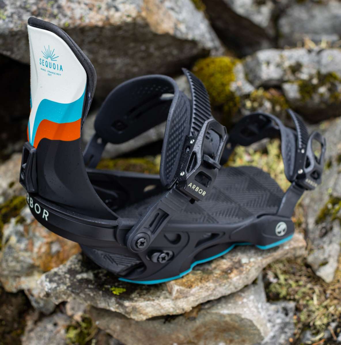 Arbor Women's Sequoia Snowboard Bindings 2024 - A black snowboard binding with a white, blue and orange graphic on the strap.