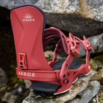 Arbor Women's Sequoia Snowboard Bindings 2024 - A pair of red snowboard bindings with white lettering, featuring a sunburst logo above the word "Sequoia".