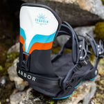 Arbor Women's Sequoia Snowboard Bindings 2024 - A white, blue and orange snowboard binding with a black strap that says "ARBOR" in white letters.