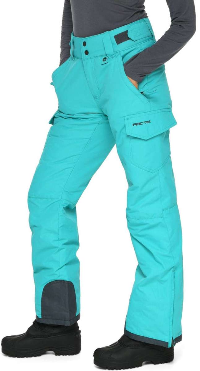 Arctix Women's Snowsports Cargo Pants 2023 - A pair of women's snow sports cargo pants in a solid teal color with two front pockets and one back pocket.