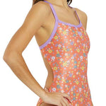 Arena Women's Lydia Jacoby Simone Manuel Challenge Back One Piece Swimsuit - A coral-colored one-piece swimsuit with a floral pattern of white, yellow, and blue flowers.