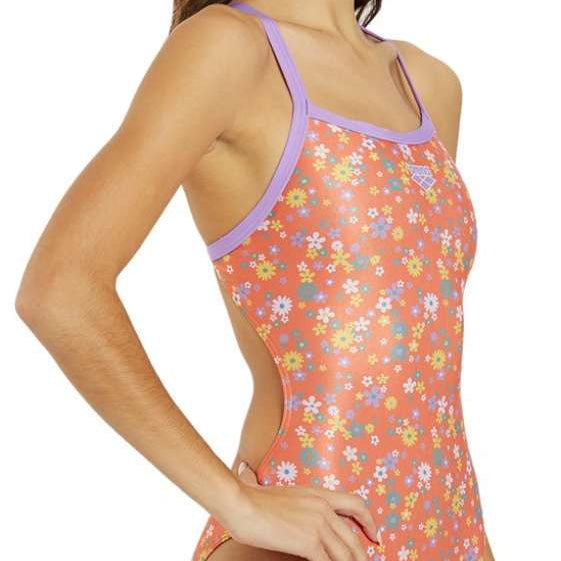 Arena Women's Lydia Jacoby Simone Manuel Challenge Back One Piece Swimsuit - A coral-colored one-piece swimsuit with a floral pattern of white, yellow, and blue flowers.