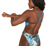 Arena Women's Lydia Jacoby Simone Manuel Challenge Back One Piece Swimsuit - A blue one-piece swimsuit with a tropical leaf pattern and thin straps on the back.