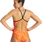 Arena Women's Puzzled Light Drop Back One Piece Swimsuit - A one-piece swimsuit with a light orange background and white geometric shapes, featuring a low back design.