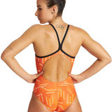 Arena Women's Puzzled Light Drop Back One Piece Swimsuit - A one-piece swimsuit with a light orange background and white geometric shapes, featuring a low back design.