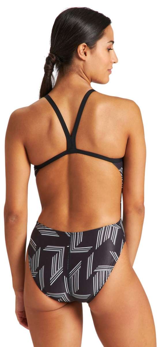 Arena Women's Puzzled Light Drop Back One Piece Swimsuit - A black one-piece swimsuit with a geometric pattern of white lines and shapes, featuring a light drop back design.