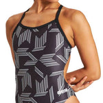 Arena Women's Puzzled Light Drop Back One Piece Swimsuit - A black one-piece swimsuit with a geometric pattern of white lines and shapes.