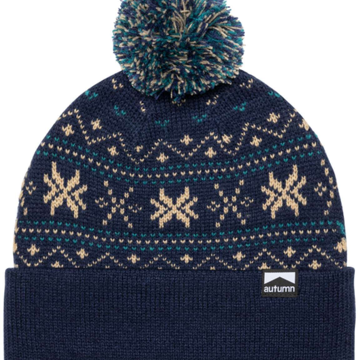 Autumn Surplus Wonderland Beanie 2023 - A navy blue beanie with a snowflake pattern and a large pom-pom on top.
