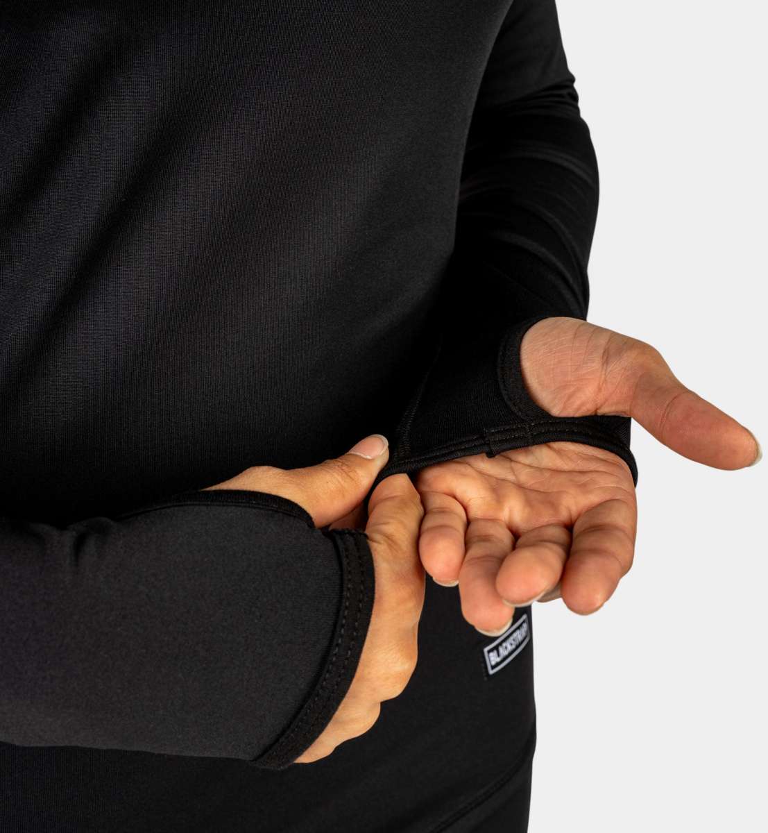 BlackStrap Cloudchaser Crew Top Baselayer 2024 - A black crew-neck top with a subtle white logo on the left chest and a small tag on the bottom right side.