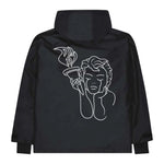 Beyond Medals Anorak 2L Shell Jacket 2024 - A black jacket with a white graphic of a woman holding an Olympic torch on the back.