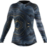 BlackStrap Women's Cloudchaser Hoodie 2024 - A black hoodie with a white and grey marbled pattern, featuring gold accents on the hood and sleeve cuffs.