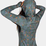 BlackStrap Women's Cloudchaser Hoodie 2024 - A black hoodie with a white and orange logo on the chest, featuring a woman wearing it from behind.