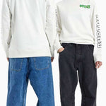 Burton 2011 Nug Crew 2024 - A white long-sleeve shirt with green and black lettering on the chest and back, featuring a crew neck and long sleeves.