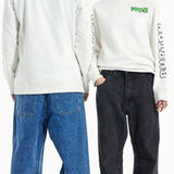 Burton 2011 Nug Crew 2024 - A white long-sleeve shirt with green and black lettering on the chest and back, featuring a crew neck and long sleeves.