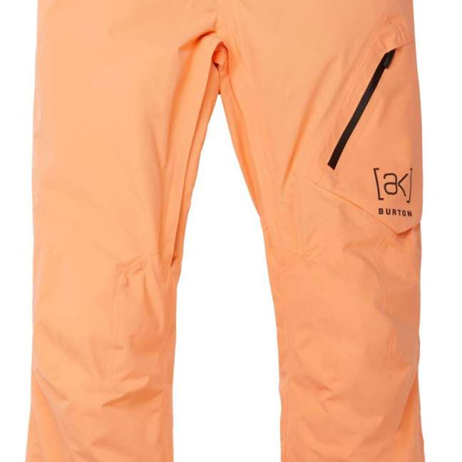 Burton AK GORE-TEX Cyclic Pant 2023 - A pair of light orange snow pants with a black zipper on the right thigh.