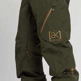 Burton AK GORE-TEX Cyclic Pant 2023 - Dark green pants with a zippered pocket on the right thigh and a small Burton logo in gold on the left leg.