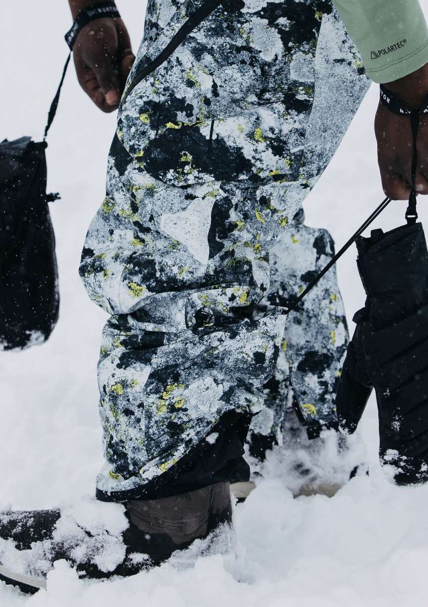 Burton AK GORE-TEX Cyclic Pant 2023 - Black snow pants with yellow and white abstract pattern, featuring black zippers on side pockets.