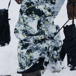 Burton AK GORE-TEX Cyclic Pant 2023 - Black snow pants with yellow and white abstract pattern, featuring black zippers on side pockets.